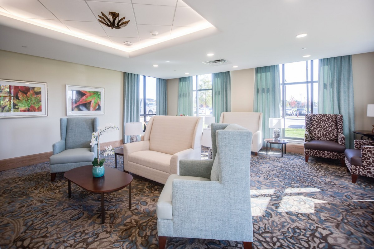 A cozy and well-lit living room featuring comfortable seating and elegant decor.