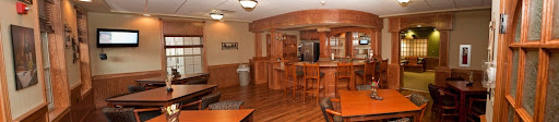 A well-designed recreational kitchen and bar area featuring wooden elements and a modern aesthetic.