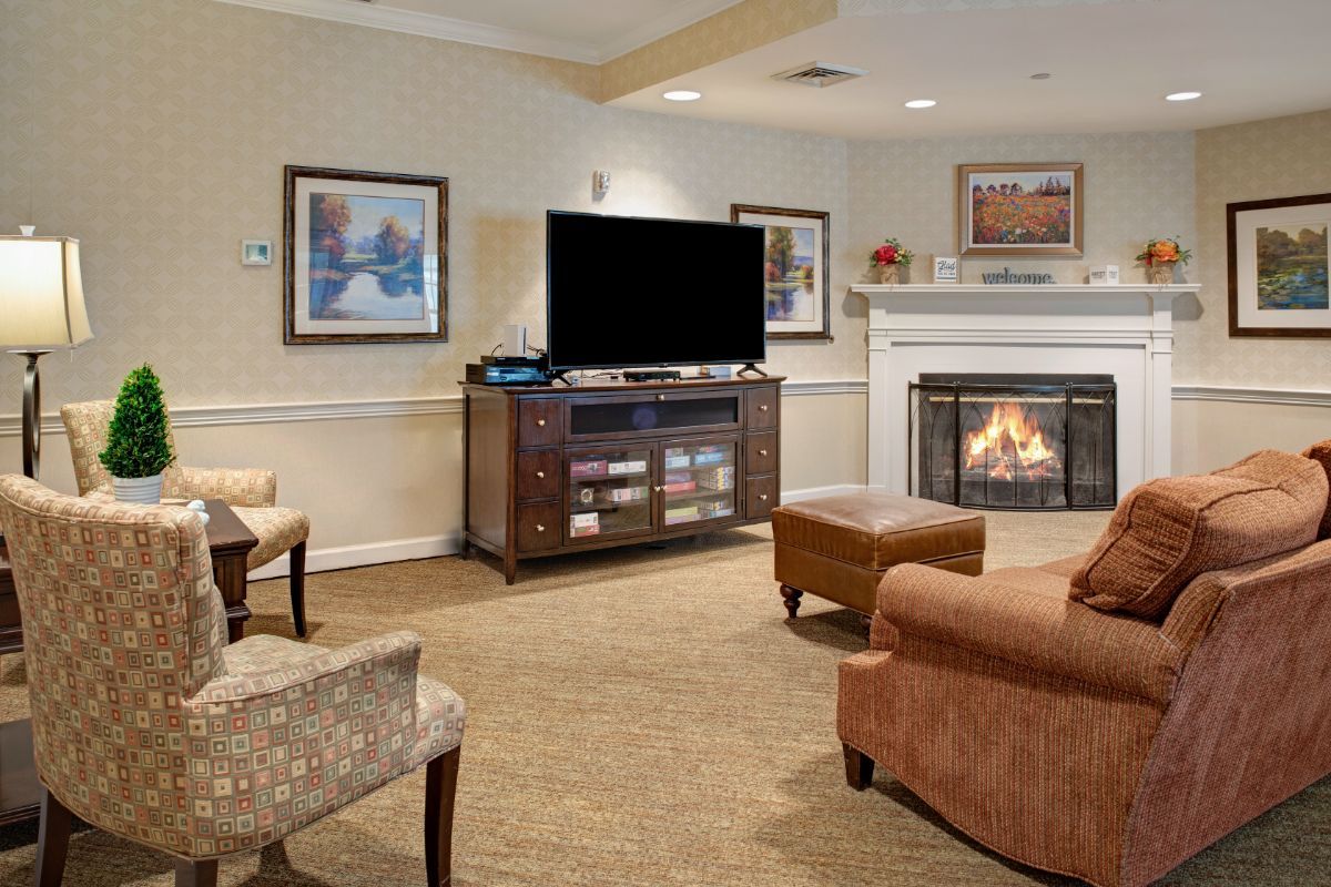A cozy living room featuring a fireplace, television, and comfortable seating.