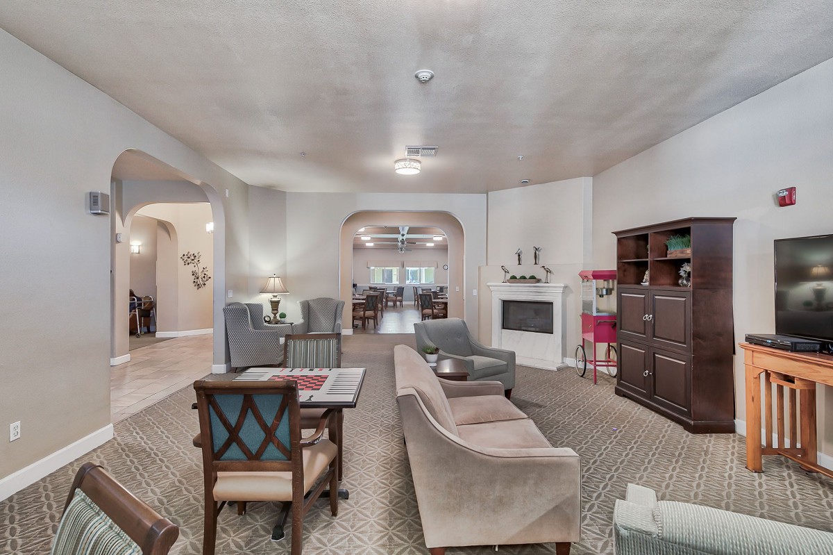 A spacious living room with a cozy seating area and a fireplace.