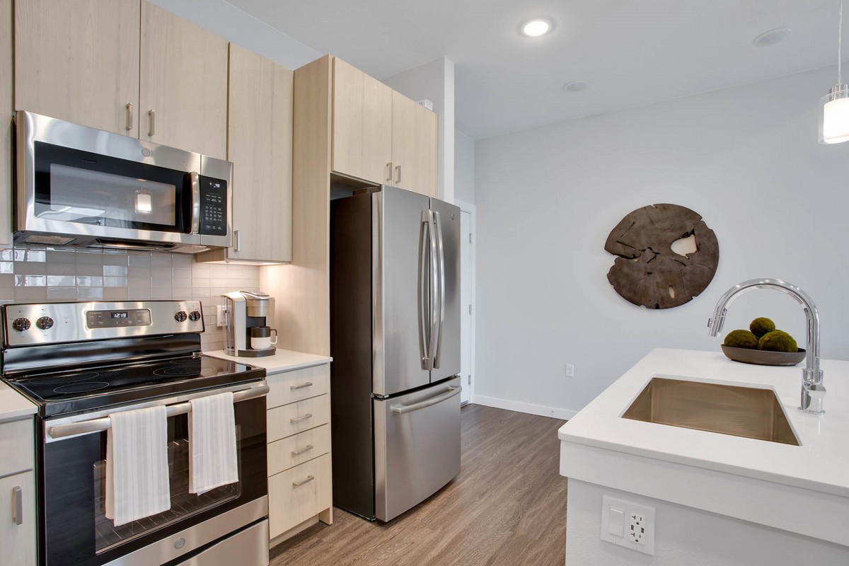 A modern kitchen featuring stainless steel appliances and a sleek design.