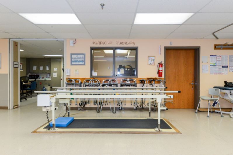 A hospital dialysis room equipped with medical equipment for patient treatment.