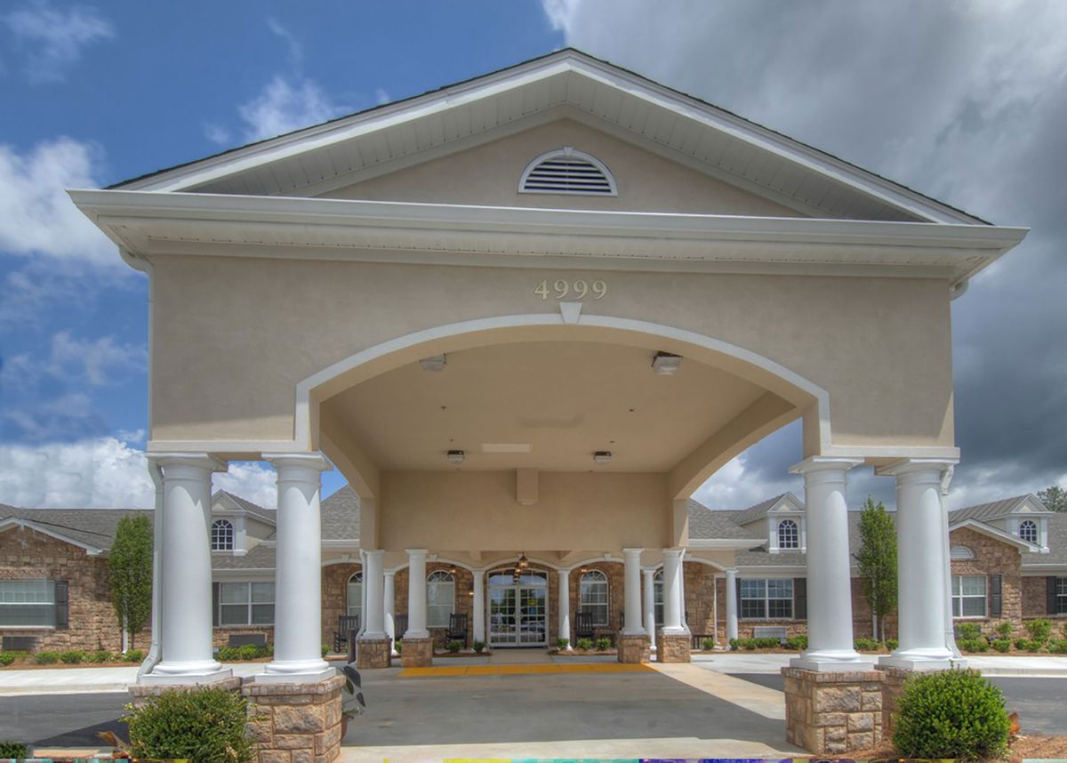 A grand entrance with columns and a covered driveway.