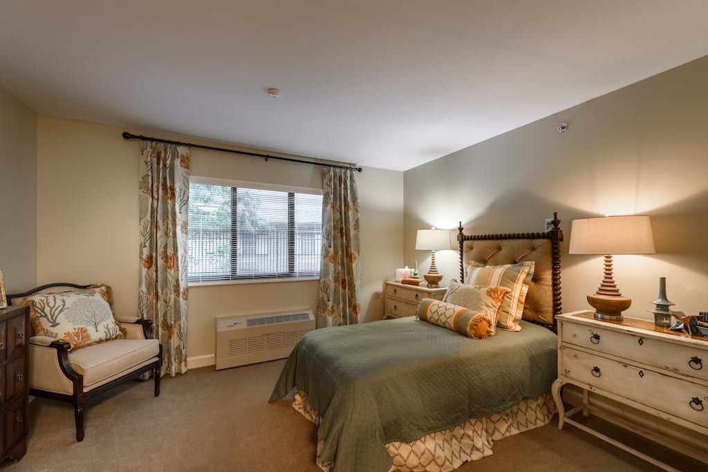 A cozy and elegantly decorated bedroom with soft lighting.