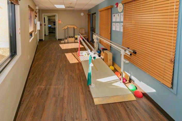 A rehabilitation room equipped with parallel bars for physical therapy exercises.