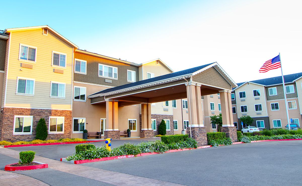A modern hotel with a welcoming entrance and well-maintained landscaping.