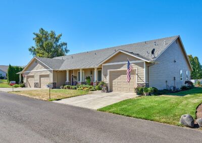 A suburban house with a well-maintained lawn and driveway.