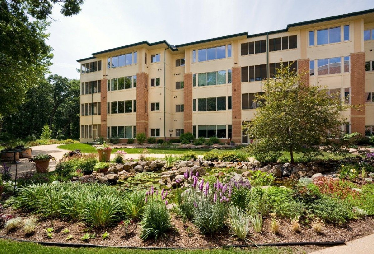 A well-maintained apartment building with beautiful garden landscaping.
