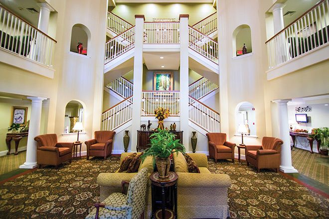 A well-decorated lobby with symmetrical stairs and comfortable seating arrangements.