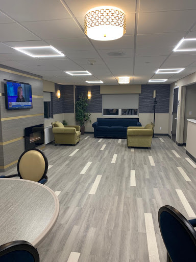 A modern lounge area featuring comfortable seating, a television, and contemporary design elements.