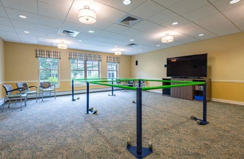 A therapy room featuring parallel bars for rehabilitation exercises.