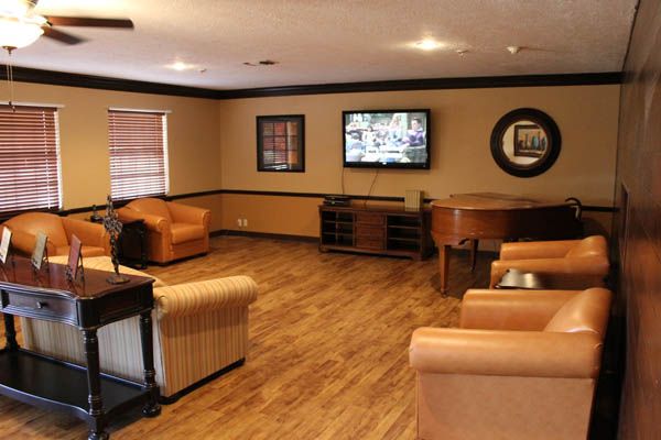 A cozy living room with comfortable seating and a TV on the wall.