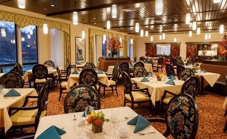 An elegant restaurant interior with neatly arranged tables and chairs.