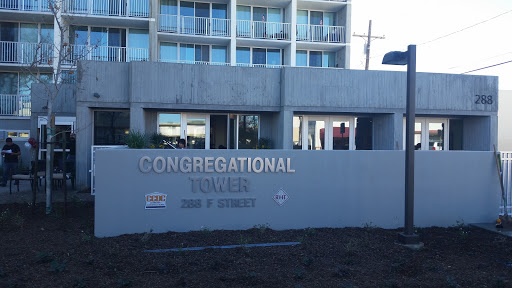 A view of Congregational Tower with a clear sign indicating its name.