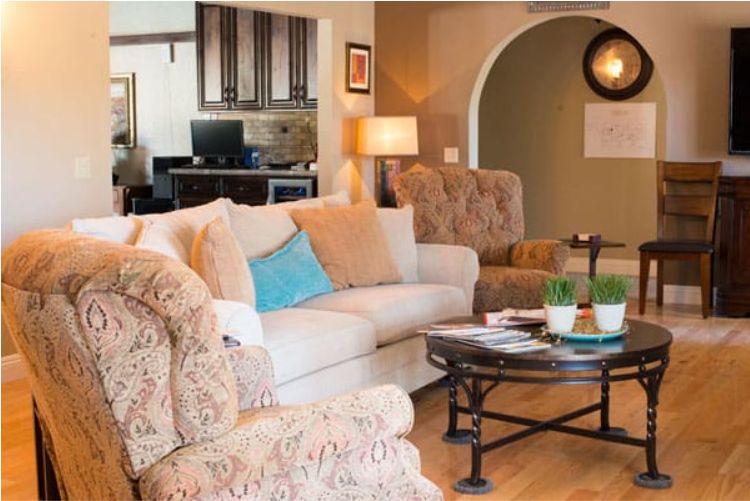 A cozy living room featuring a comfortable sofa, patterned armchairs, and a coffee table.