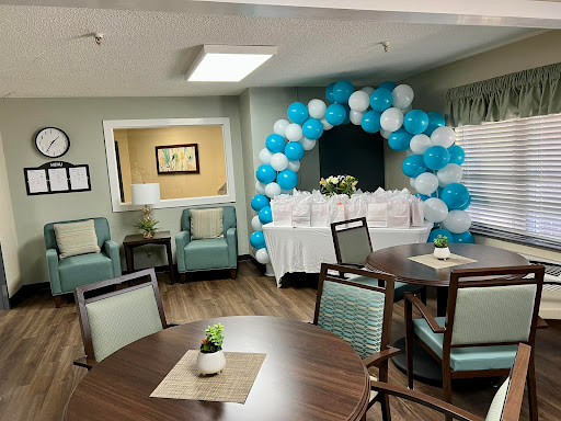 A festive event space adorned with a vibrant blue and white balloon arch, perfect for celebrations.