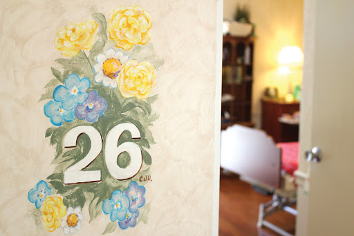 A beautifully decorated entryway featuring the number 26 surrounded by floral artwork.