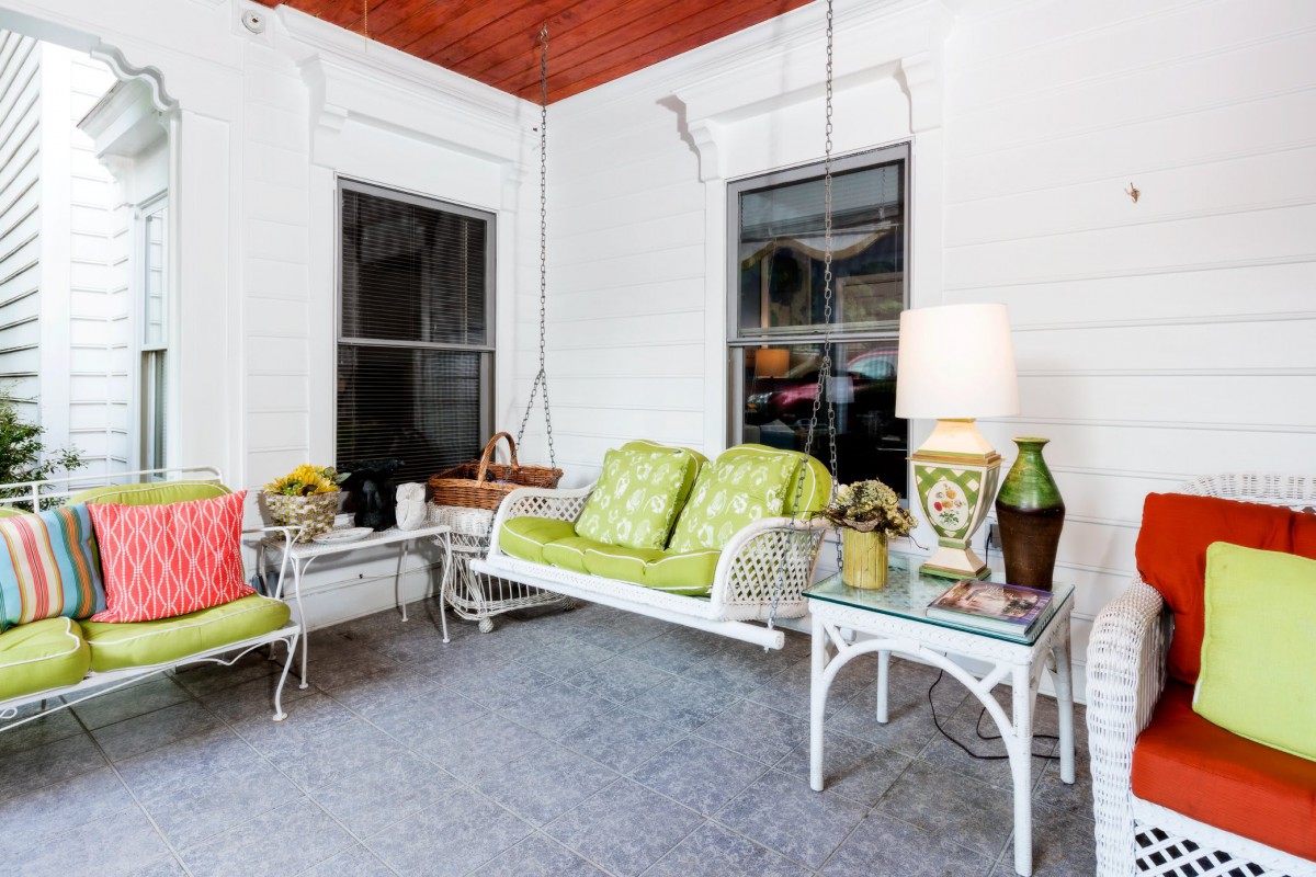 A cozy porch with comfortable seating and stylish decor.