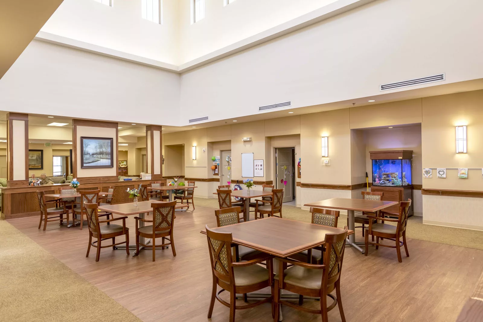 A spacious and modern dining area with multiple tables and chairs.