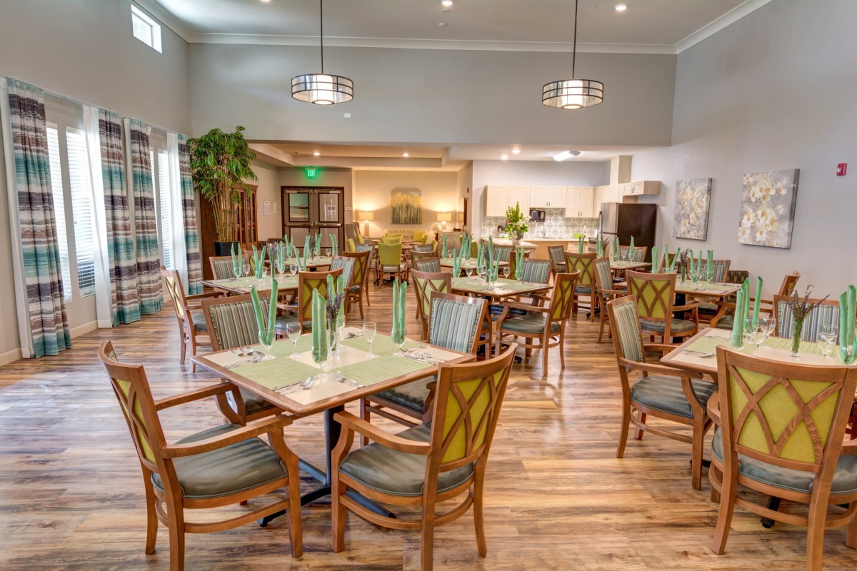 A well-designed restaurant dining area with neatly arranged tables and chairs, featuring tasteful decor and ambient lighting.
