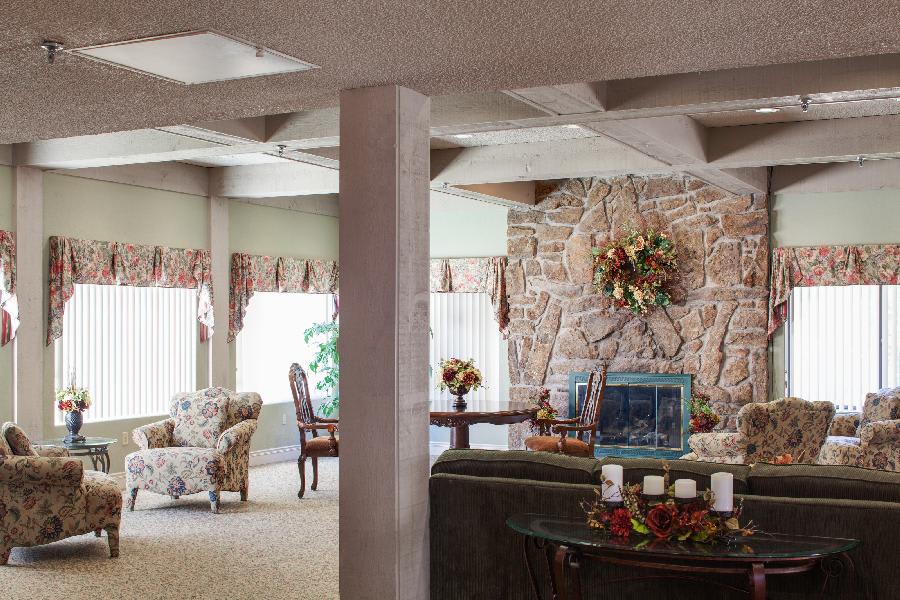 A cozy living room with elegant decor and a stone fireplace.