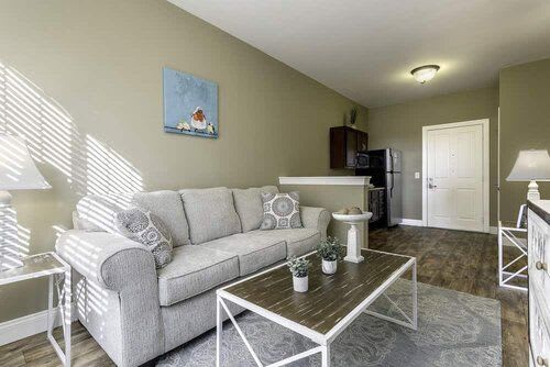 A modern living room with a comfortable sofa and sleek coffee table in an apartment setting.