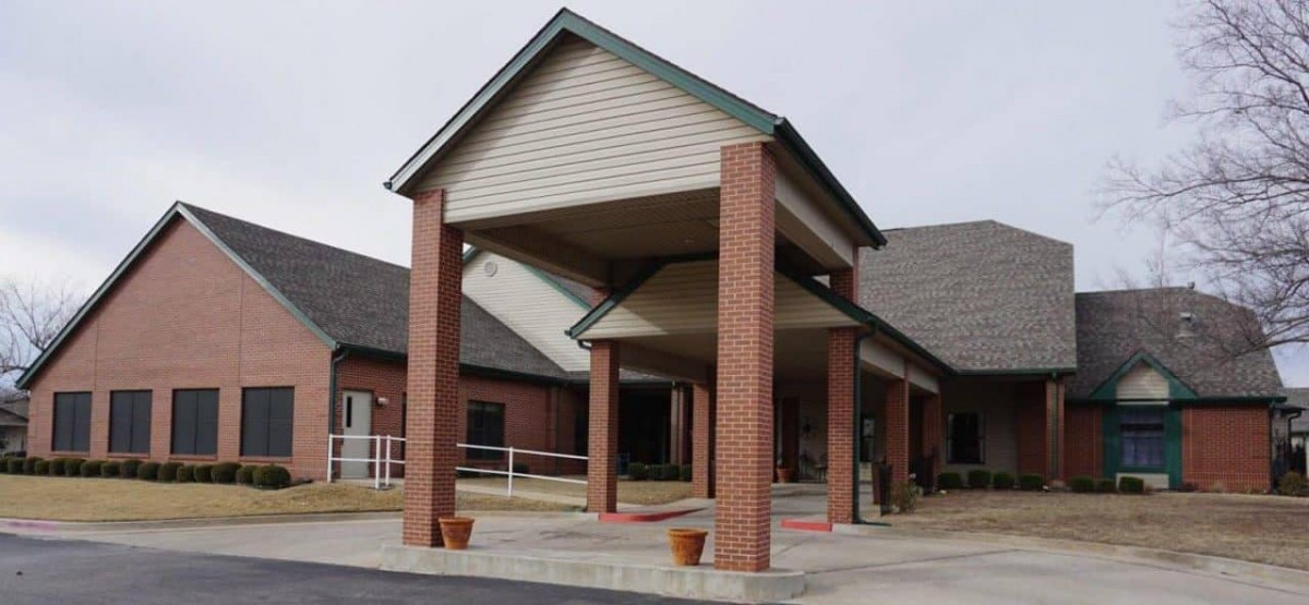 A brick building with a covered entrance.