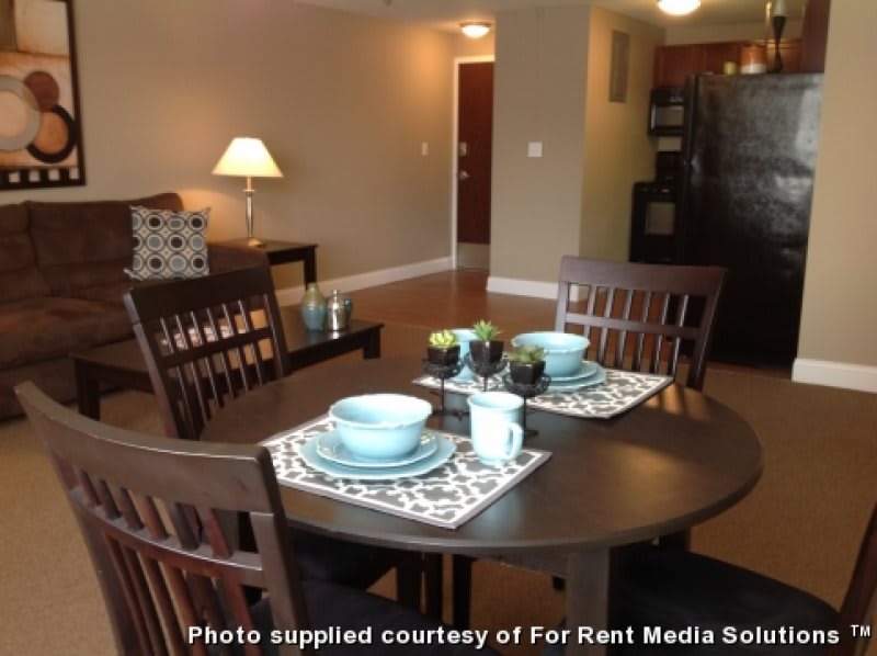 A cozy dining area in a modern apartment with place settings on the table.