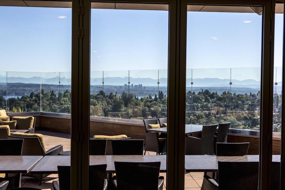 A scenic outdoor patio with tables and chairs overlooking a beautiful landscape.