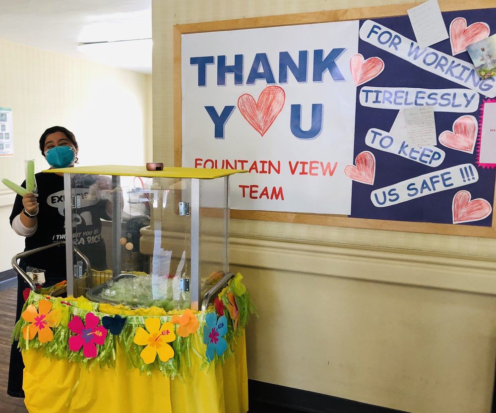 A thank you display for healthcare workers, featuring a decorated table with flowers and a sign expressing appreciation for their tireless efforts to keep us safe.