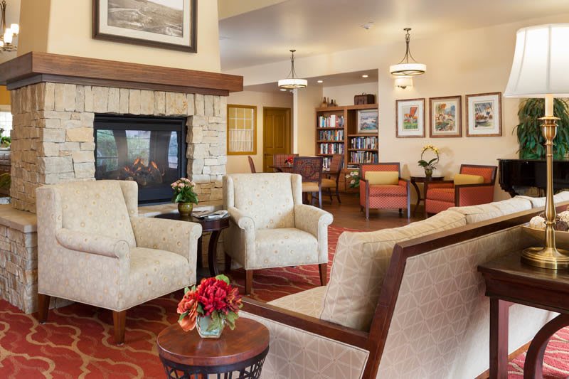 A cozy living room with comfortable seating and a fireplace.