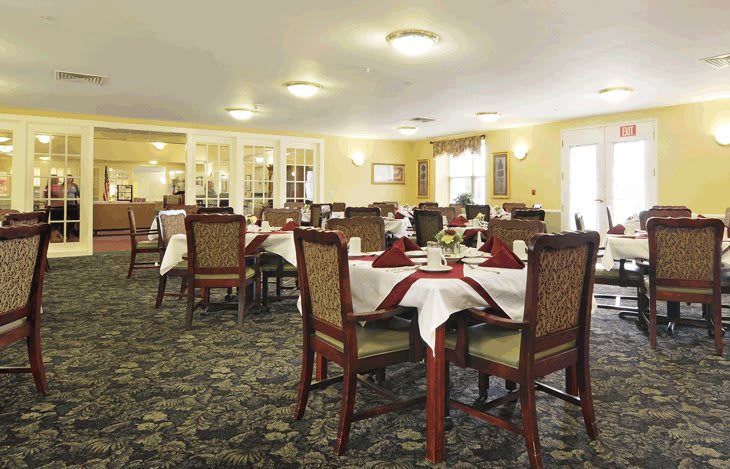 An elegant dining room with neatly arranged tables and chairs.