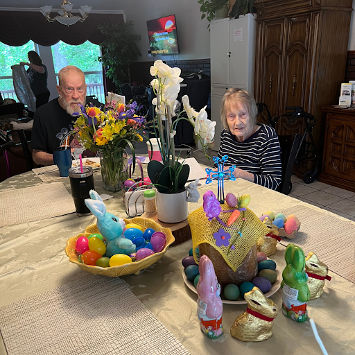A joyful family gathering during Easter, surrounded by colorful decorations and flowers.
