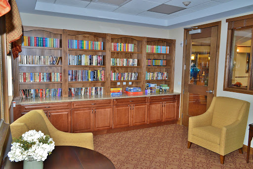 A cozy reading nook featuring a well-stocked bookshelf and comfortable seating.