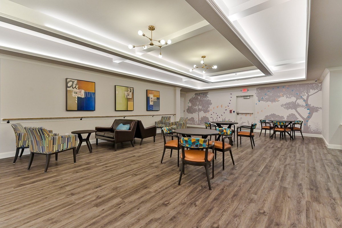 A modern dining area with contemporary furniture and artwork.