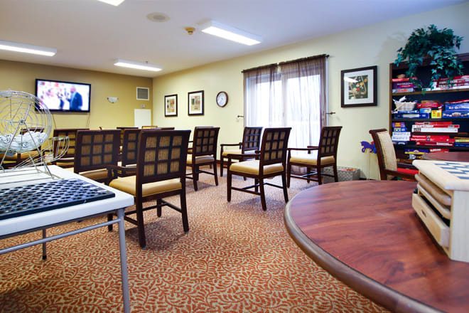An empty conference room with arranged chairs, tables, and wall decorations.