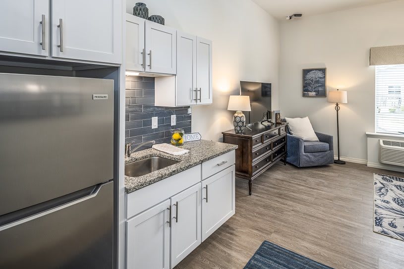 A modern apartment interior featuring a compact kitchen and cozy living area.