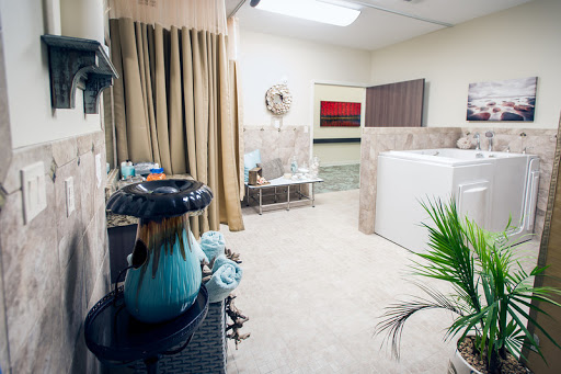 A modern bathroom setup featuring a washing machine, decorative elements, and a touch of greenery.