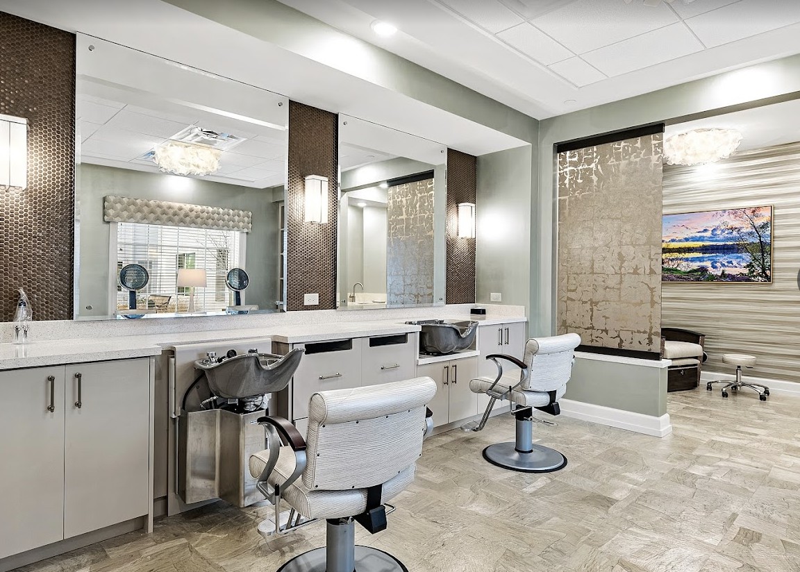 A modern hair salon interior with stylish chairs and mirrors.