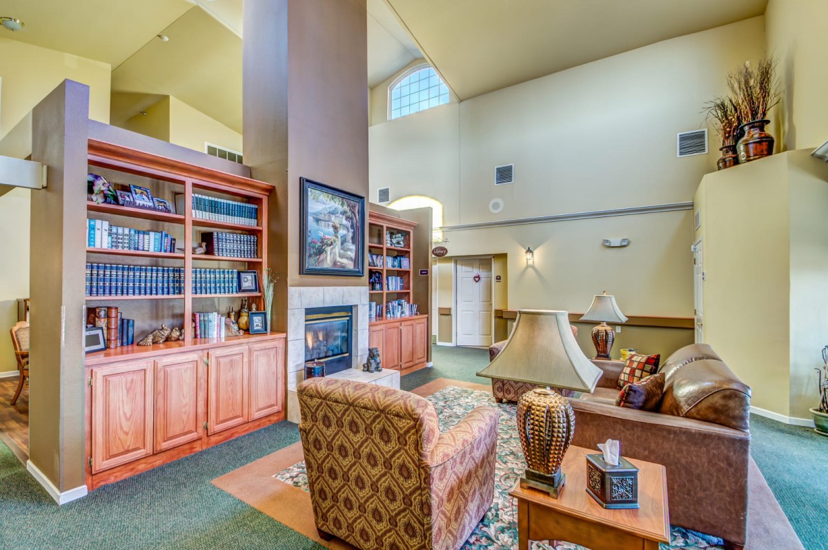 A cozy living room with bookshelves and a fireplace.