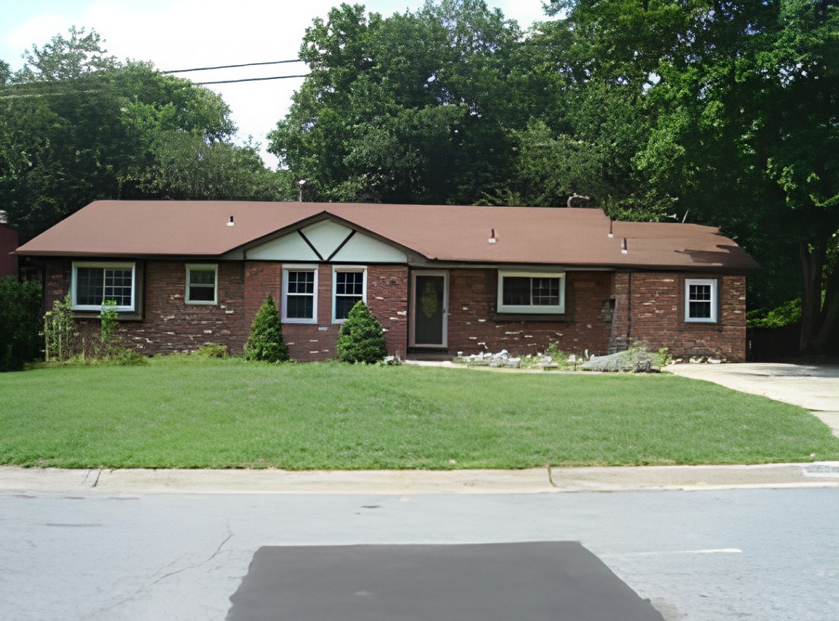 A single-story brick house with a well-maintained lawn and surrounding trees.