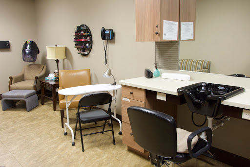 An interior view of a medical office featuring seating and healthcare equipment.