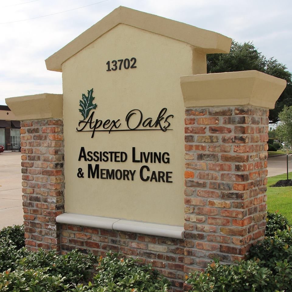 A sign for Apex Oaks Assisted Living & Memory Care facility.
