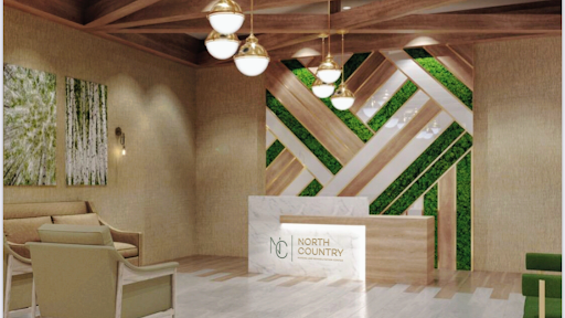 A contemporary reception area with wooden accents and greenery.
