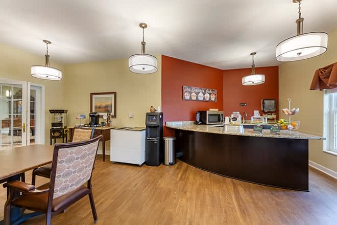A modern cafe interior with a coffee station and seating area.