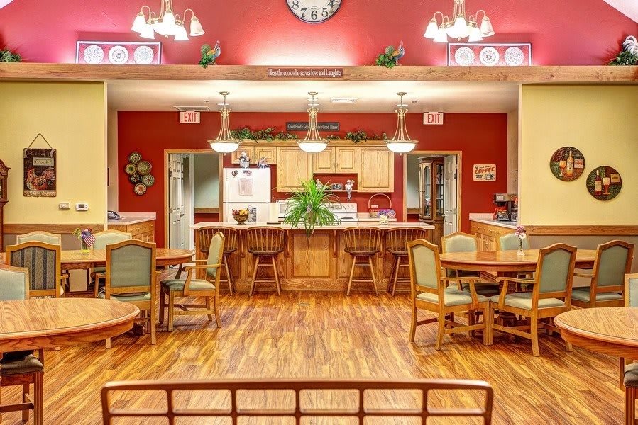 A warm and inviting kitchen and dining area with wooden floors and cozy lighting.