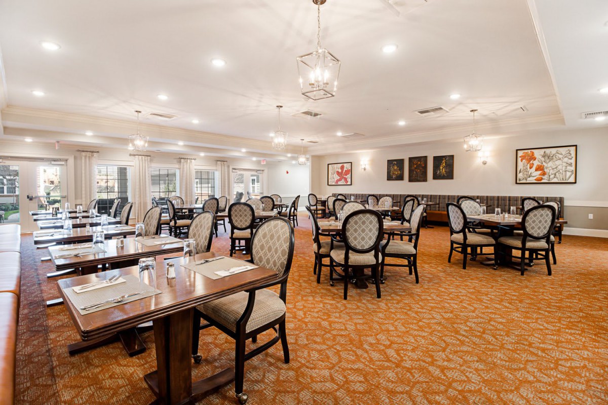 An elegant restaurant dining room with neatly arranged tables and chairs.