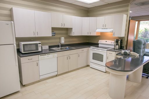 A modern kitchen featuring essential appliances and ample storage.