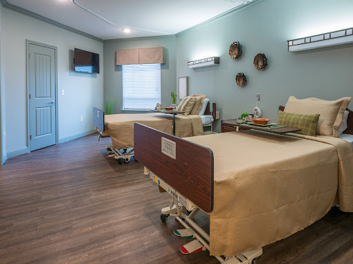 A modern hospital patient room equipped with comfortable beds and a welcoming atmosphere.