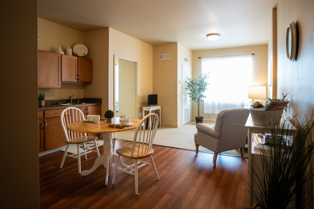 A cozy, naturally lit living space with a small dining area and kitchen.